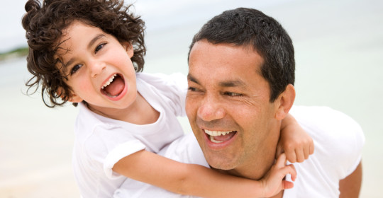 Father and son smiling
