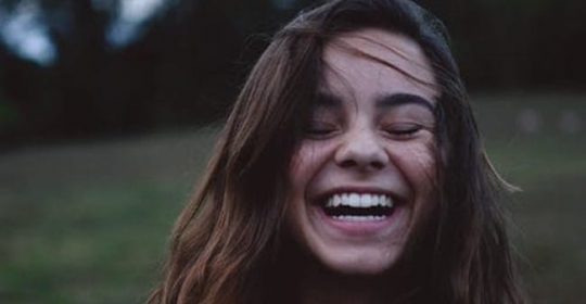 young lady smilling in field